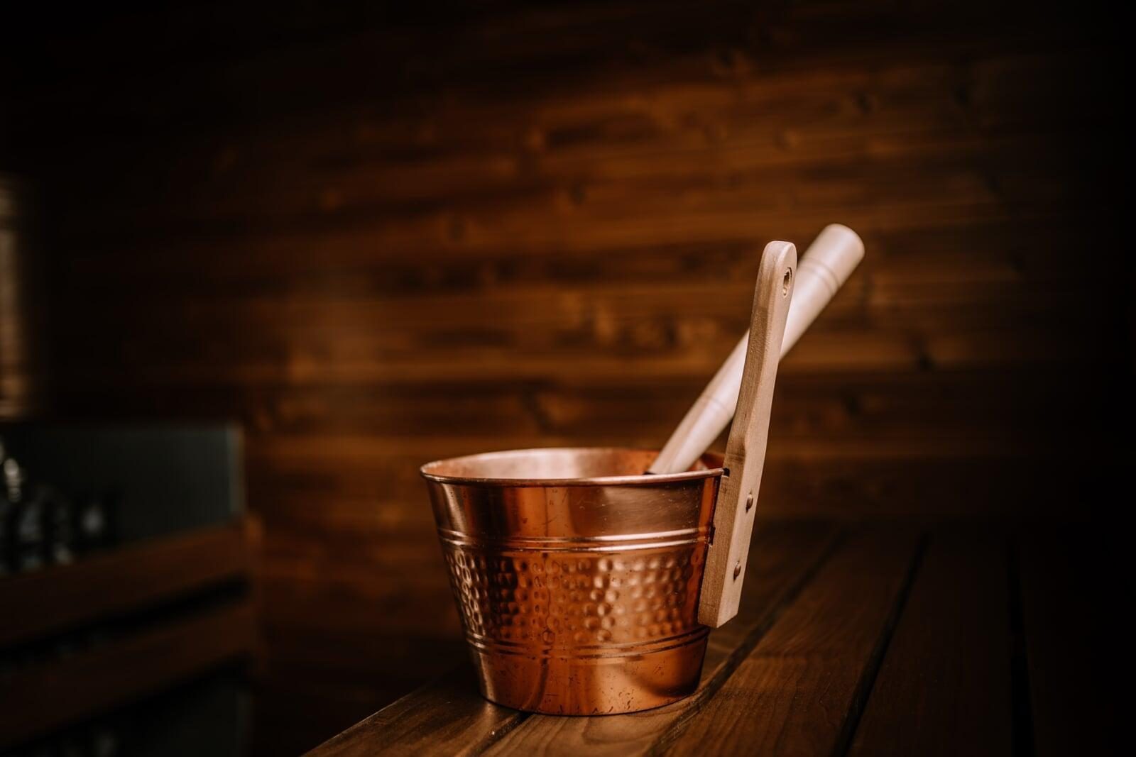 Copper sauna bucket on the bench